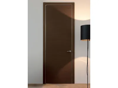 Porta a battente in legno Wengè e stipite con coprifili alluminio Trait di Albed